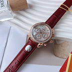Luxury wristwatch with red leather strap, rose-gold case, diamond-look bezel, white dial chronograph
