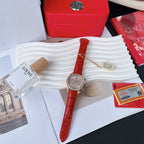 Red leather strap wristwatch with round silver bezel and visible crown, analog dial