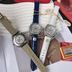 Omega chronograph watches with tan, blue, and white leather straps, jeweled silver cases.