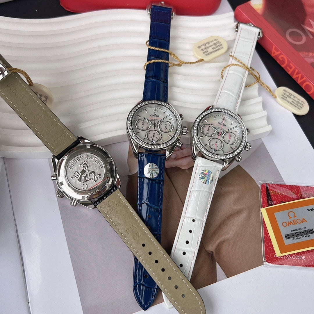 Omega chronograph watches with tan, blue, and white leather straps, jeweled silver cases.