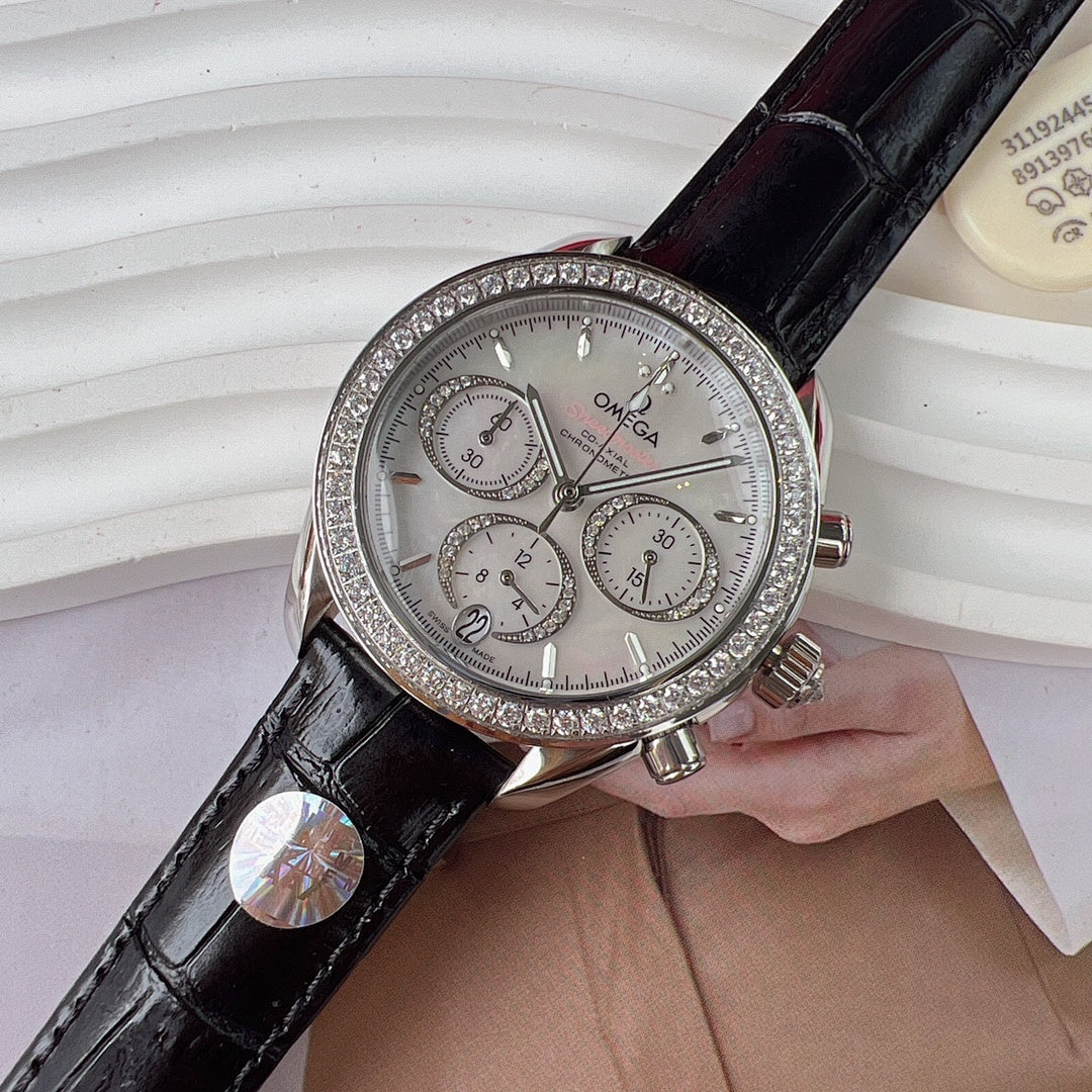 Omega chronograph watch with black leather strap, jeweled silver bezel, silver dial.