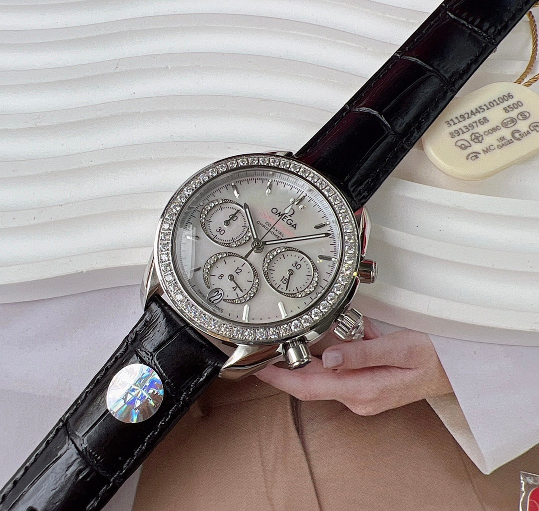 Omega chronograph watch with black leather strap, jeweled silver bezel, silver dial.