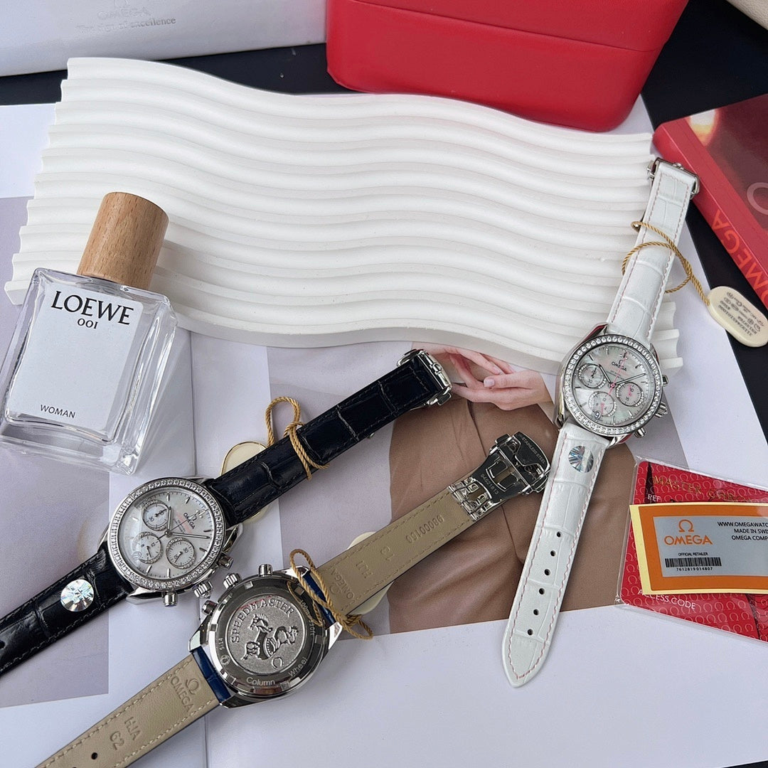 Omega chronograph watches with black and gray leather straps, silver jeweled cases.