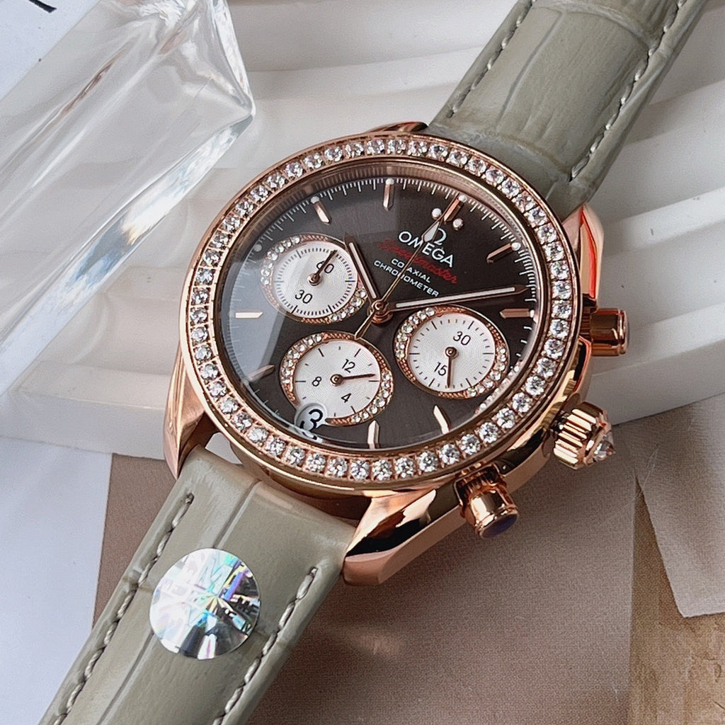 Omega chronograph wristwatch close-up, dark dial, rose gold case with diamond bezel, gray strap