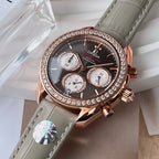 Omega chronograph wristwatch close-up, dark dial, rose gold case with diamond bezel, gray strap