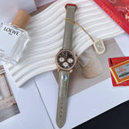 Omega watch with round dark dial, chronograph subdials, green leather strap