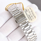 Omega wristwatch caseback with engraving, silver bracelet, hanging cream tag.