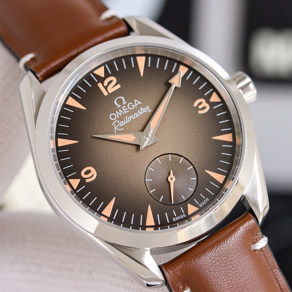 Omega leather strap wristwatch close-up with dark dial and stainless steel case, brown strap.