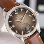 Omega leather strap wristwatch close-up with dark dial and stainless steel case, brown strap.