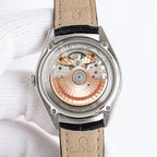 Seamaster watch caseback in silver with visible movement, beige leather strap
