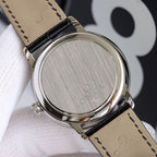 Wristwatch caseback with brushed metal finish and black leather strap underside