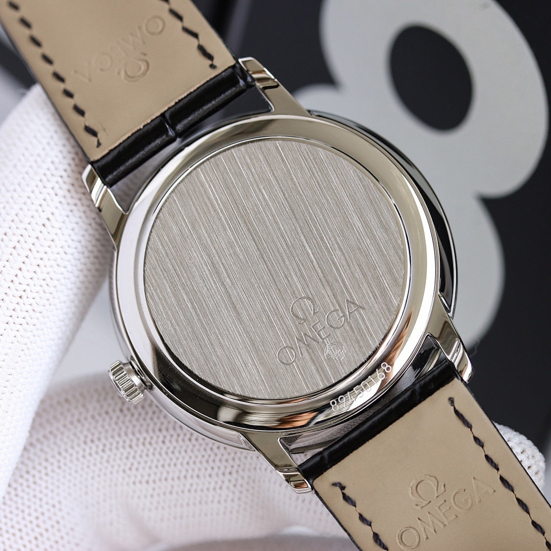 Wristwatch caseback with brushed metal finish and black leather strap underside
