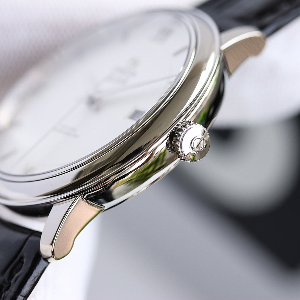 Wristwatch with silver crown and black leather strap, close-up side view