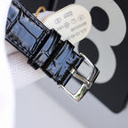 Wristwatch strap with black leather texture and silver buckle clasp