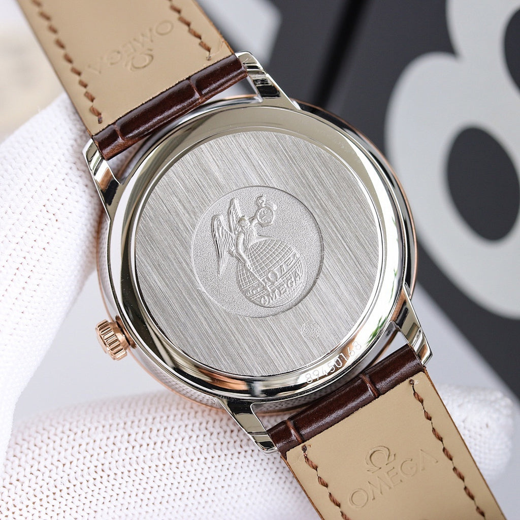 Engraved watch case back with brown leather strap and visible stitching