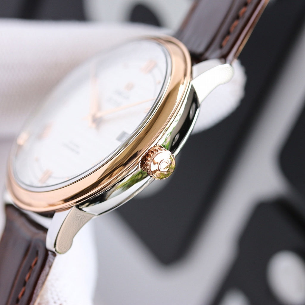 Rose gold-tone watch side view with crown and black leather strap