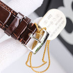 Brown leather strap watch with metal buckle and looped strap detail