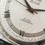 Omega De Ville watch dial close-up showing roman numerals and Co-Axial Chronometer text