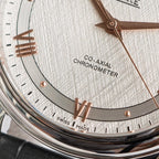 Omega wristwatch dial close-up with rose-gold markers, CO-AXIAL text, date markers