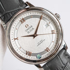 Omega wristwatch with textured white dial, rose-gold accents, date window at 3