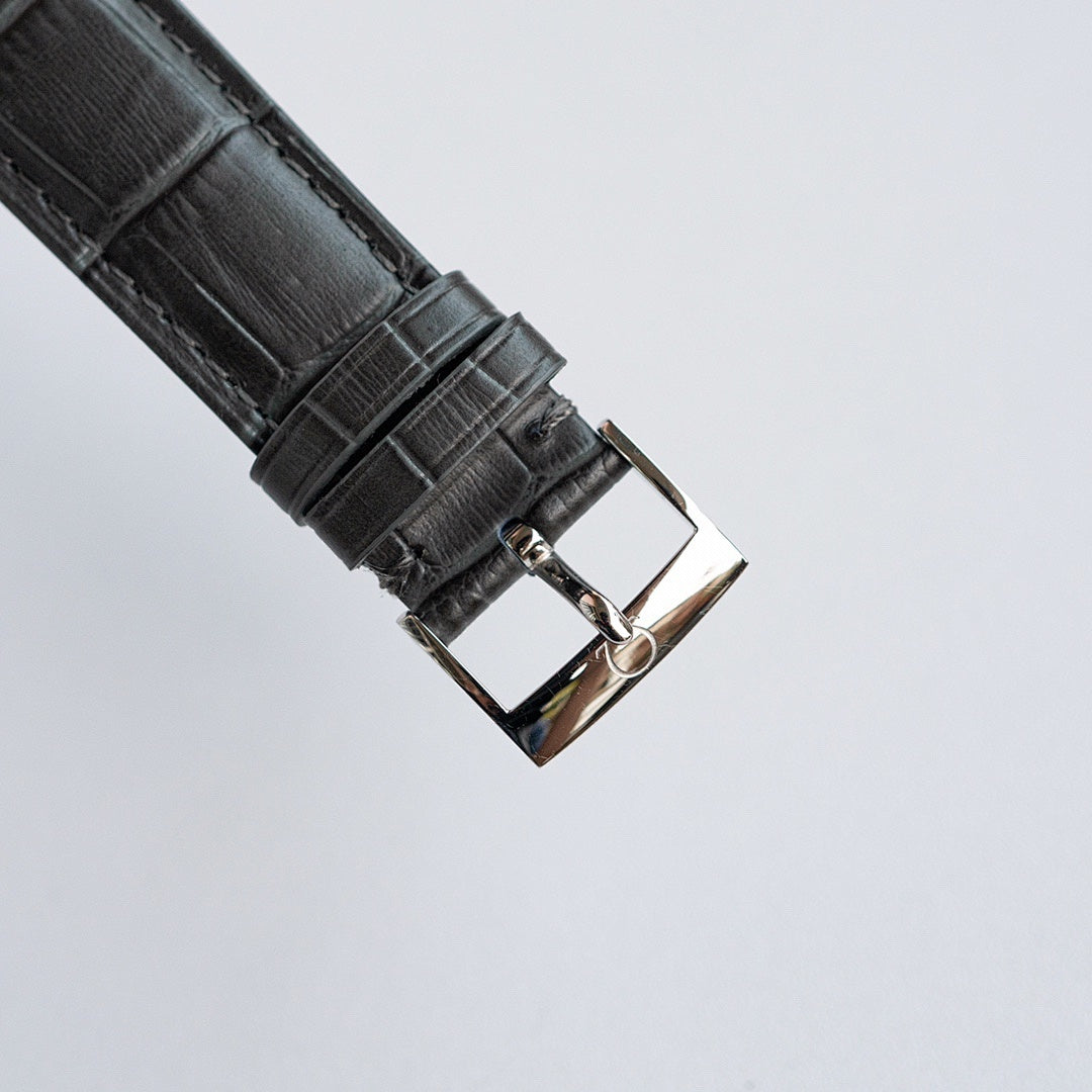 Black leather watch strap with metal buckle and clasp