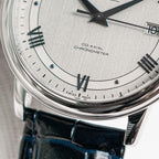 Omega De Ville watch dial close-up with Roman numerals and Co-Axial Chronometer text
