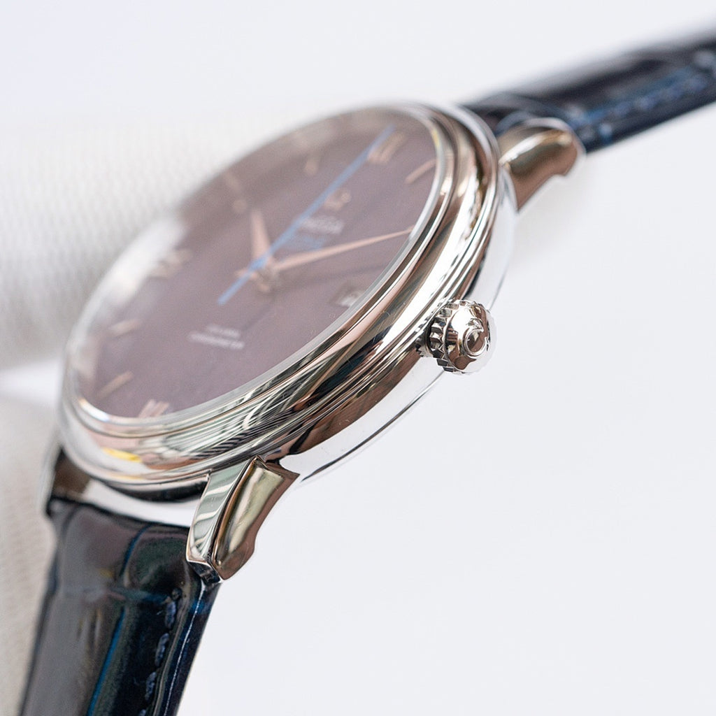 Omega watch side view with crown and blue dial, stainless steel case