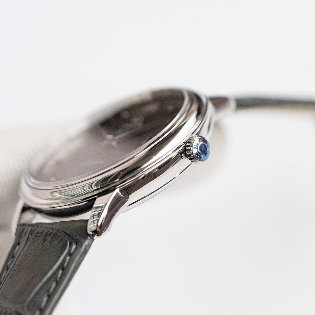Omega De Ville wristwatch side view with crown and black leather strap.