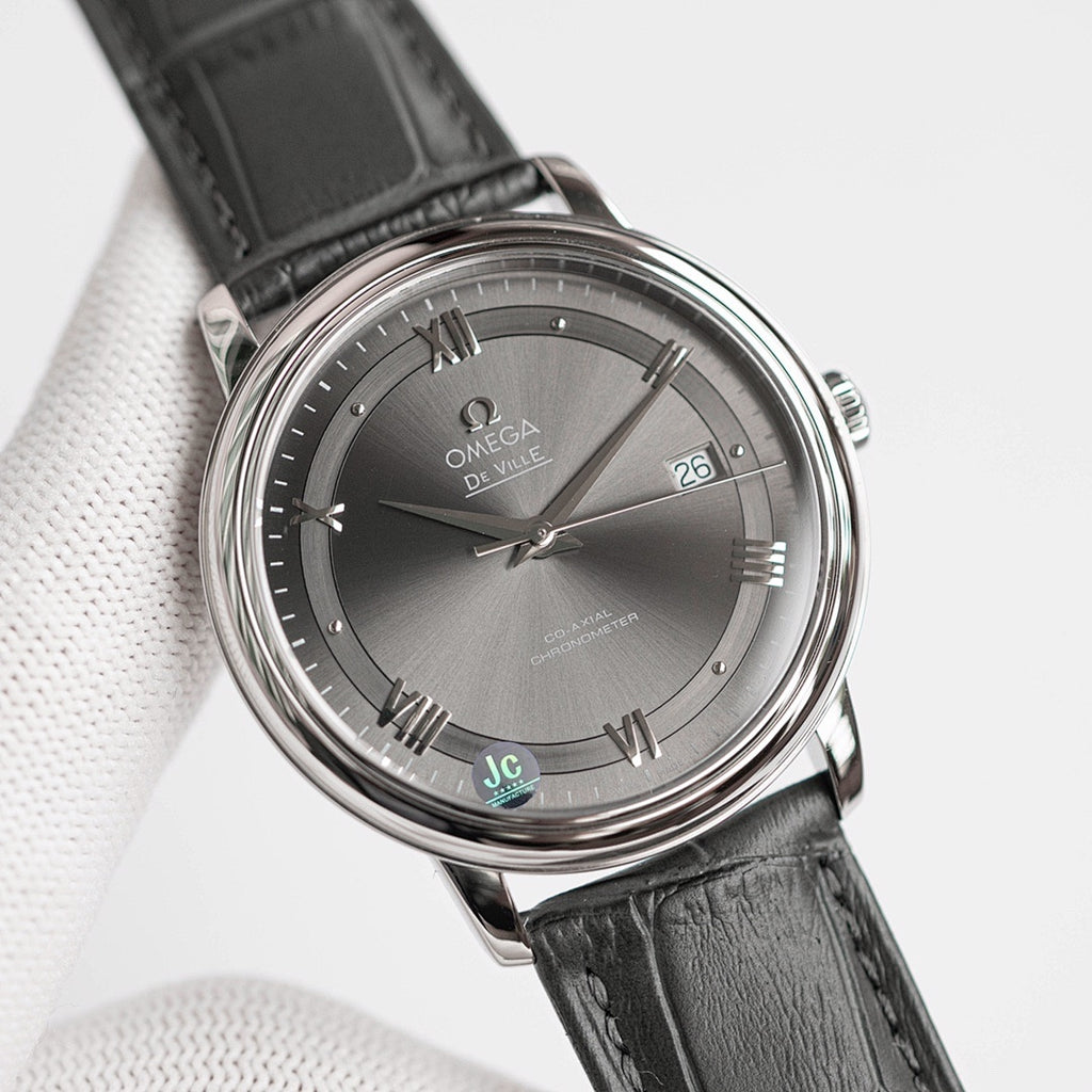 Omega De Ville wristwatch with black leather strap and dark dial, Roman numerals.