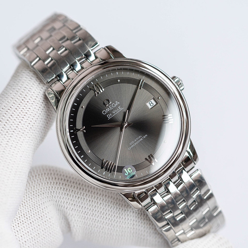 Omega De Ville wristwatch with steel bracelet and dark dial, Roman numerals.