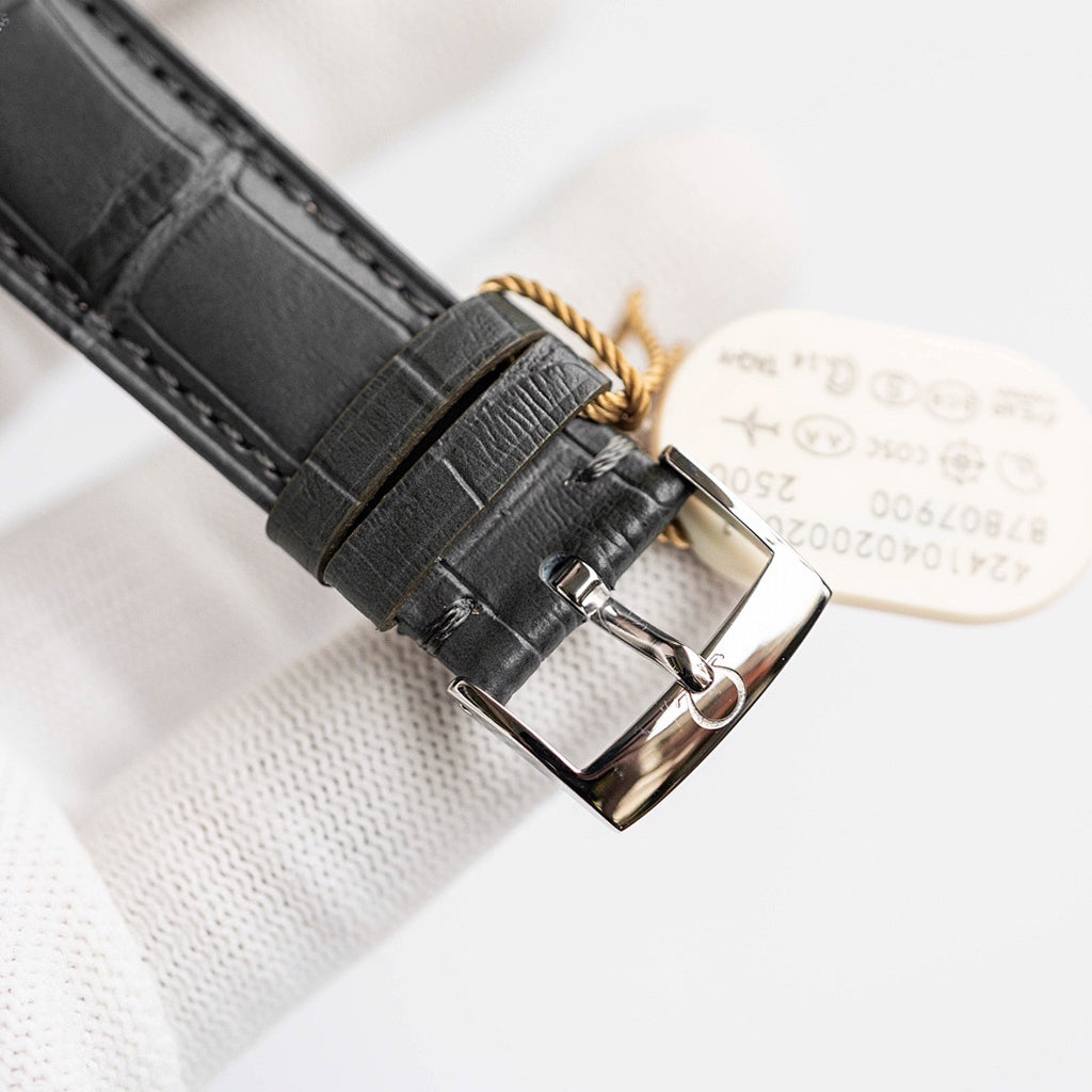 Omega De Ville watch case back with leather strap and metal buckle.