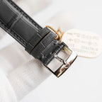 Omega De Ville watch case back with leather strap and metal buckle.