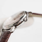 Omega De Ville watch crown and case profile with brown leather strap