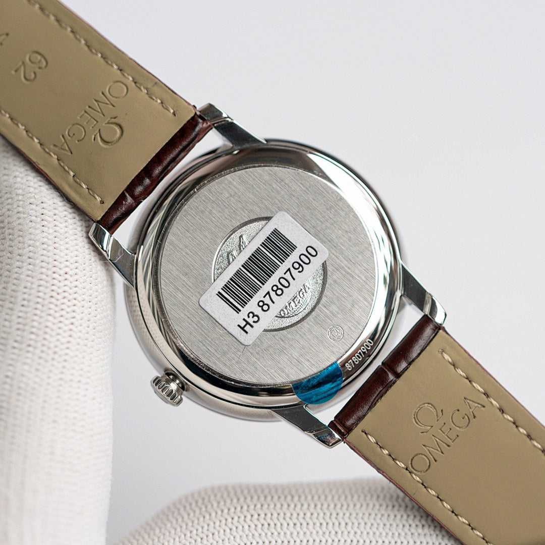 Omega De Ville caseback with brown leather strap, brushed metal back with serial numbers