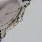 Omega watch side detail with crown and black leather strap