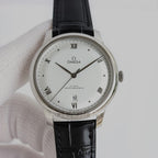Omega dress watch with white dial, black leather strap, and stainless steel case