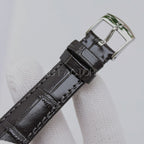 Omega watch with black leather strap and silver metal buckle clasp