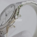 Stainless steel watch case with crown and smooth bezel, dial edge visible