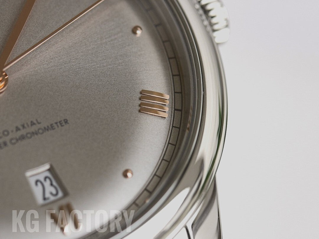 Gray textured watch dial with Roman numerals and gold-tone hour markers