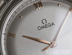 Gray dial close-up with gold-tone hands and Omega logo hour markers