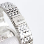 Stainless steel wristwatch bracelet with clasp and Omega logo on the buckle plate