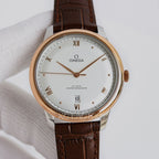 Analog wristwatch, white dial, gold-tone case, brown leather strap, day-date window