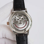 Analog watch caseback with visible gears, black leather strap