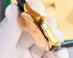 Omega wristwatch side view with black leather strap and gold-tone crown and case