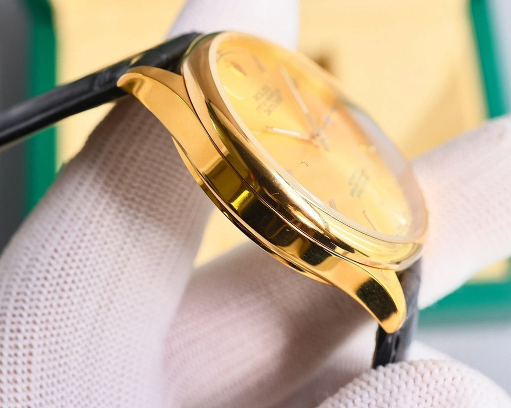 Omega wristwatch with gold-tone case and black leather strap, angled side view of crystal
