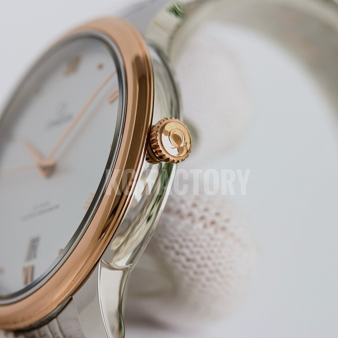 Omega wristwatch crown and gold-toned case edge with part of white dial
