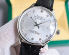 Omega wristwatch with silver dial and date window, black leather strap, angled view.