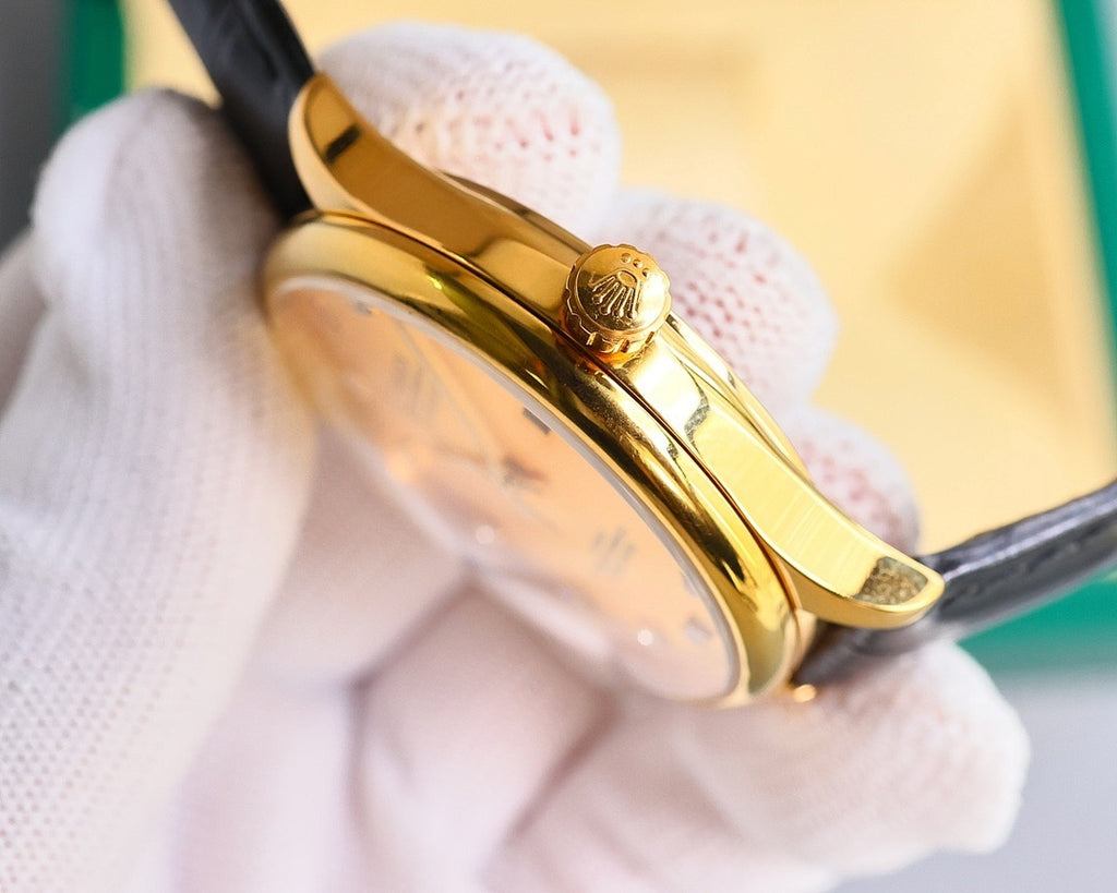 Gold-tone wristwatch side profile with black leather strap and round bezel