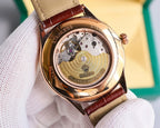 Omega watch with exposed gold-toned movement, brown leather strap, caseback view