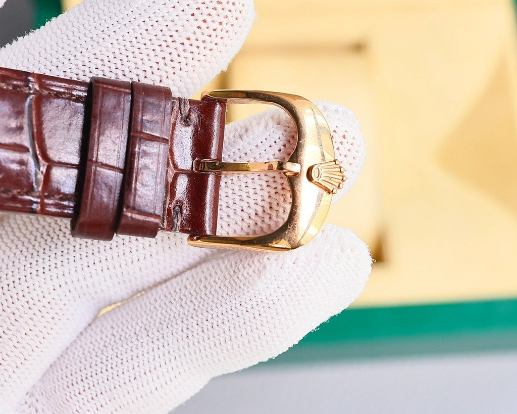 Omega watch with brown leather strap and gold-tone buckle, side profile on glove